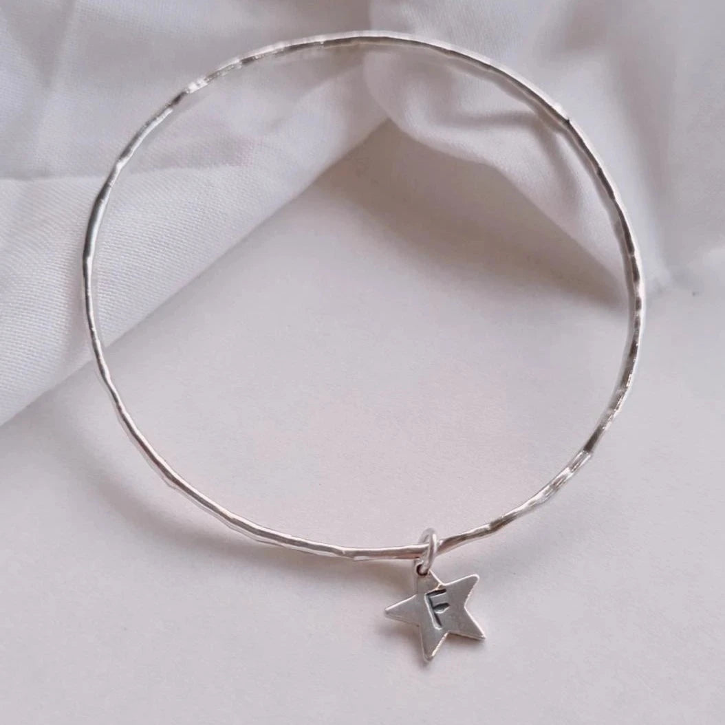 Textured silver bangle with personalised star charm.