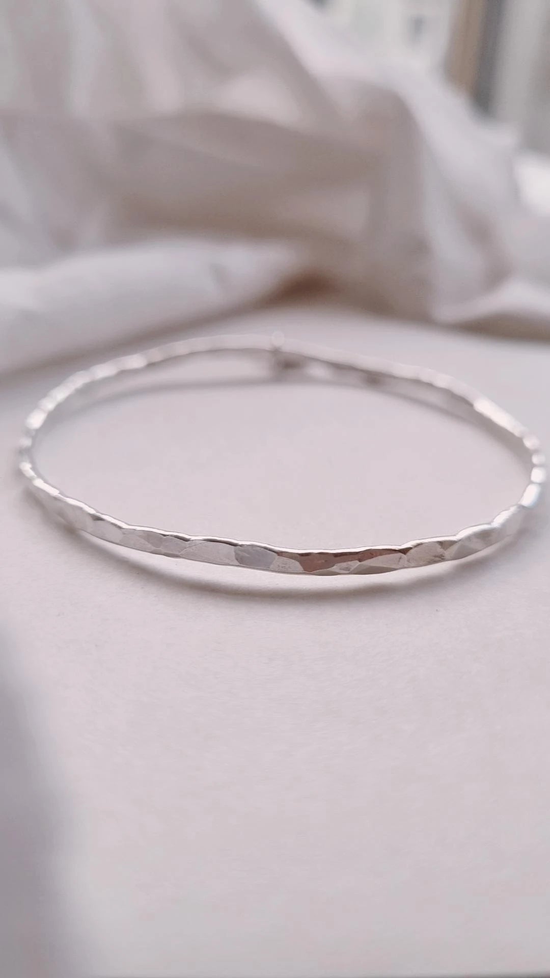 Textured silver bangle with personalised star charm.