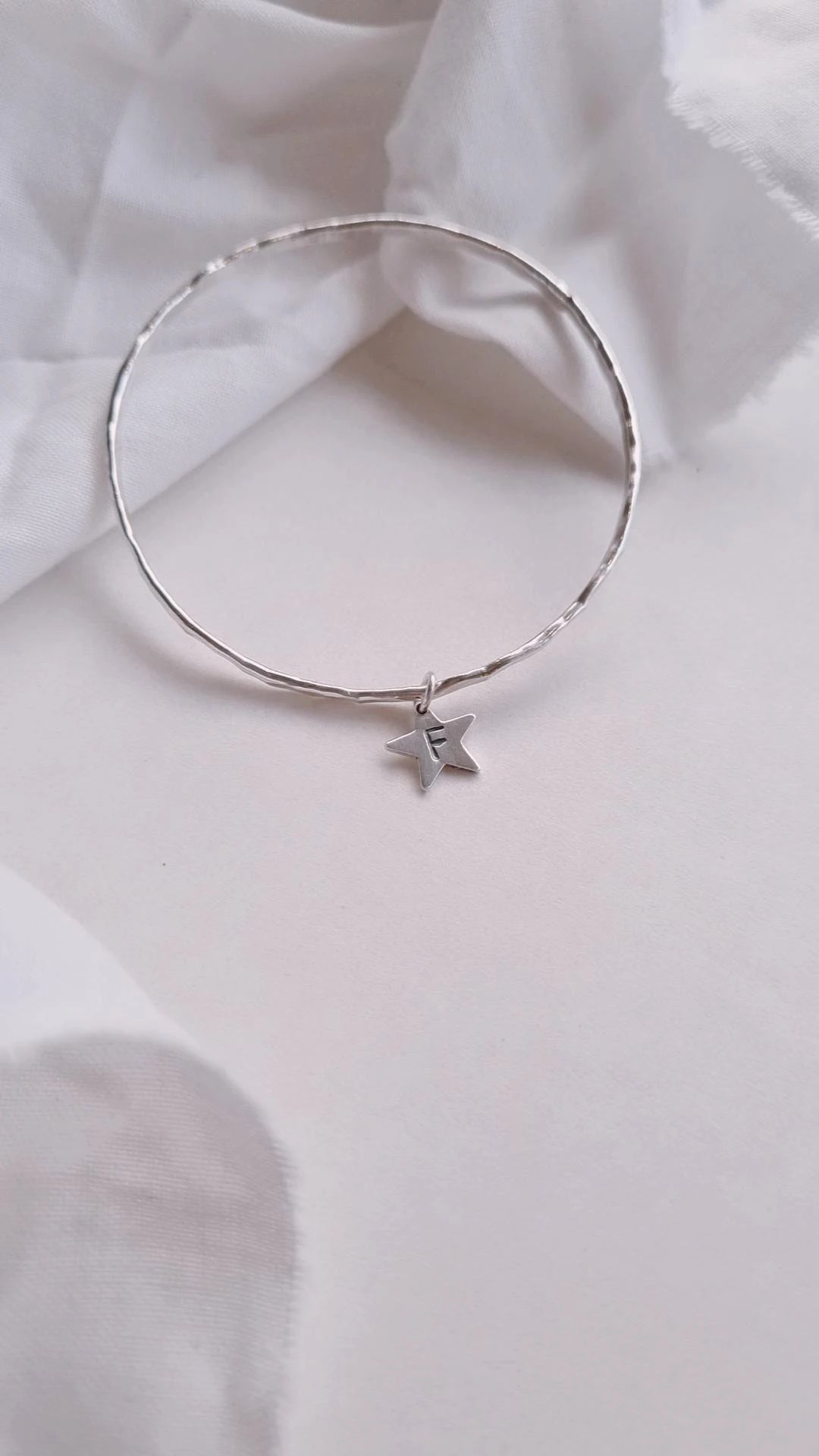 Textured silver bangle with personalised star charm.