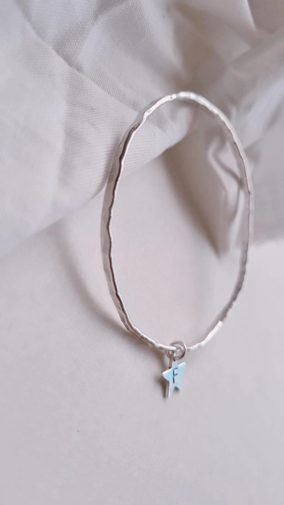 Textured silver bangle with personalised star charm.