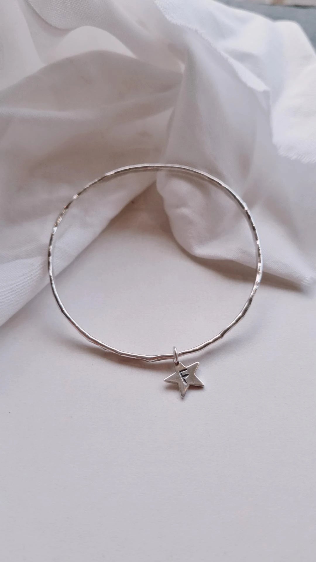 Textured silver bangle with personalised star charm.